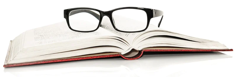 Open book with reading glasses resting on the pages